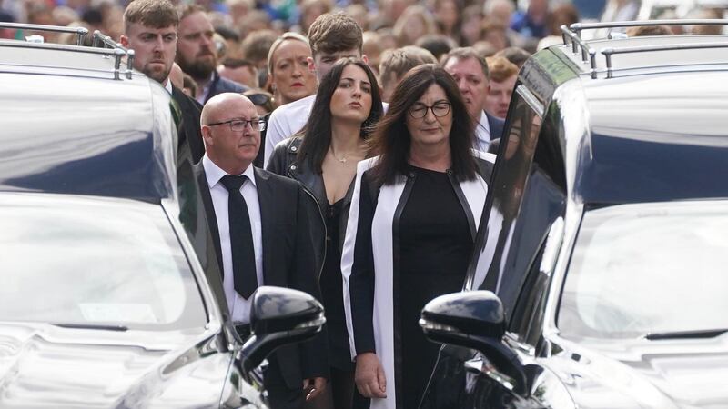 Family members and mourners follow the hearses carrying the coffins of siblings Luke and Grace McSweeney as they make their way to Saints Peter and Paul’s Church, Clonmel, Co Tipperary, ahead of their funeral service (Brian Lawless/PA)