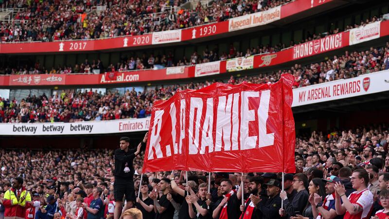 Fans hold up a banner on the 14th minute during Arsenal’s Premier League match against Bournemouth in memory of 14-year-old Daniel Anjorin