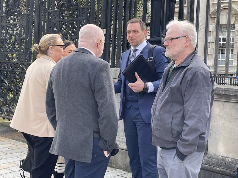 Solicitor Padraig O Muirigh (centre) with members of the families of Peter Ryan (known as Michael) and Tony Doris
