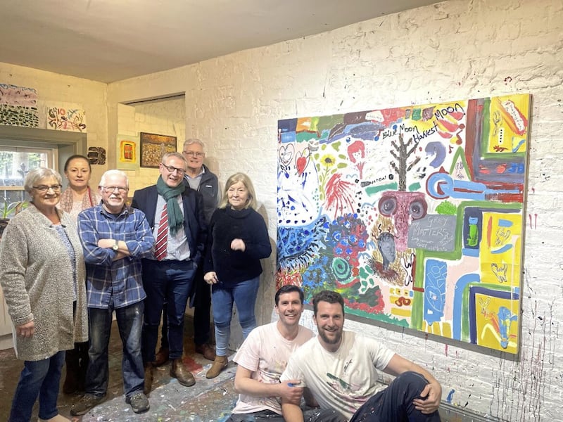 Members of the WAVE Trauma Centre group with their Minding Minds Together collaboration painting 
