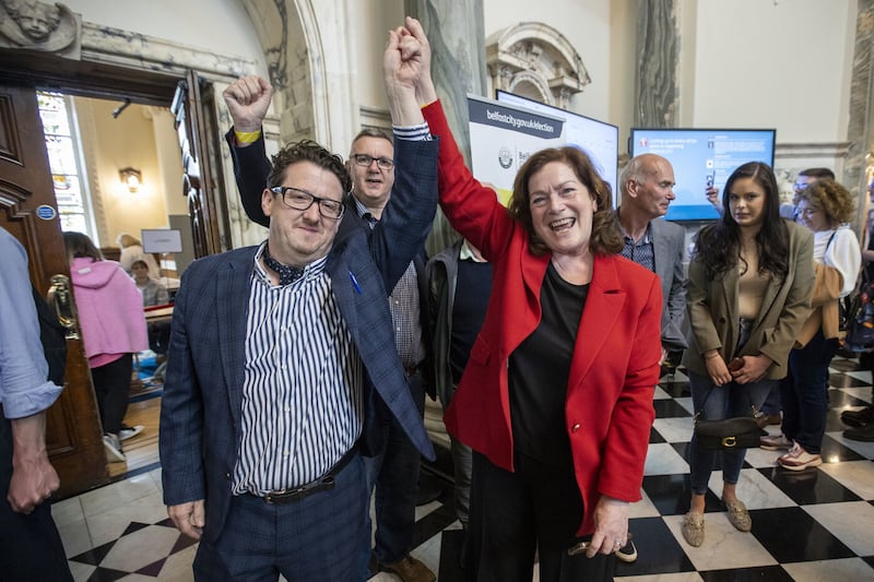 Sinn Féin Balmoral candidate Geraldine McAteer's hand is raised by party colleague Sean Napier after she was elected to serve again as a councillor at Belfast City Hall. Picture: Liam McBurney/PA 