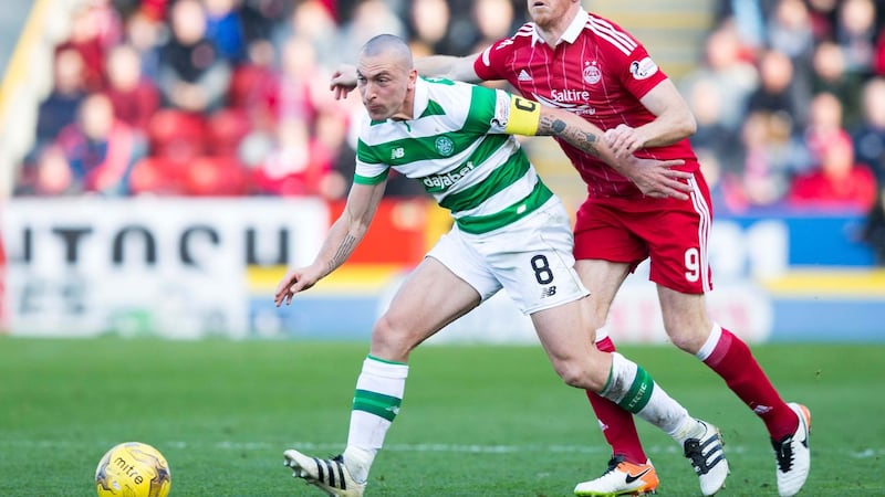 Celtic captain Scott Brown in action against Aberdeen's Adam Rooney during Saturday's Ladbrokes Premiership match at Pittodrie<br />Picture by PA