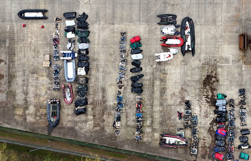 A view of small boats and engines used to cross the Channel by people thought to be migrants at a warehouse facility in Dover, Kent