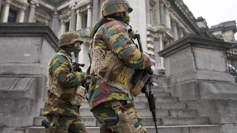 Soldiers patrol outside the main court building in Brussels where extradition hearings against Salah Abdeslam. Picture by Associated Press