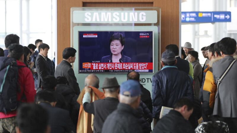People watch a TV screen showing the live broadcast of South Korean President Park Geun-hye&#39;s address, at the Seoul Railway Station in Seoul, South Korea, yesterday. Picture by Lee Jin-man, Associated Press 