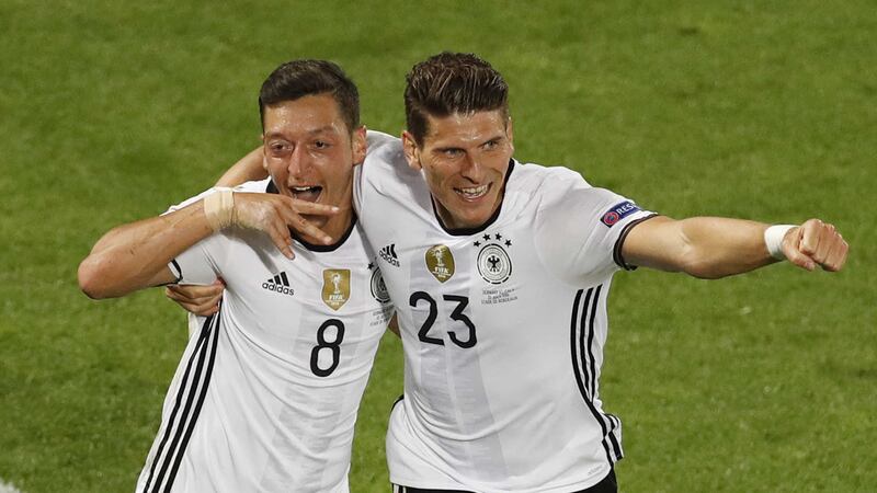 Germany's Mario Gomez (right) celebrates with goal scorer Mesut Ozil during Saturday night's Euro 2016 quarter-final against Italy <br />Picture by AP&nbsp;