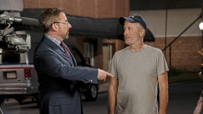 Steve Carell with director Jon Stewart on the set of Irresistible 