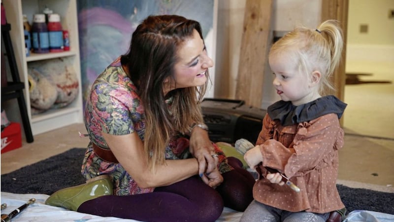 Rachel McBride at home in her art studio with two-year old daughter Harper. Picture by Hugh Russell 