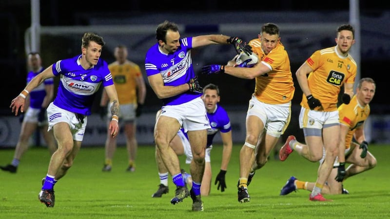 Antrim&#39;s Conor Murray in action against Laois&#39;s Gareth Dillon and Trevor Collins in the Allianz Football League Division Three in Portloaise Picture: Seamus Loughran. 