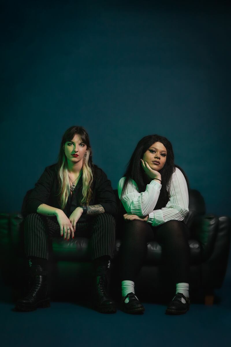 A photo of Alannagh and Hannah of Derry pop punk band Cherym, seated on a couch