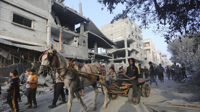 Palestinians look at destruction in Rafah caused by the Israeli bombardment (Hatem Ali/AP)