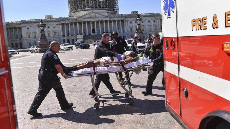 A medical team transport the person believed to be the suspect in a shooting at the US Capitol complex on Monday PICTURE: AP 