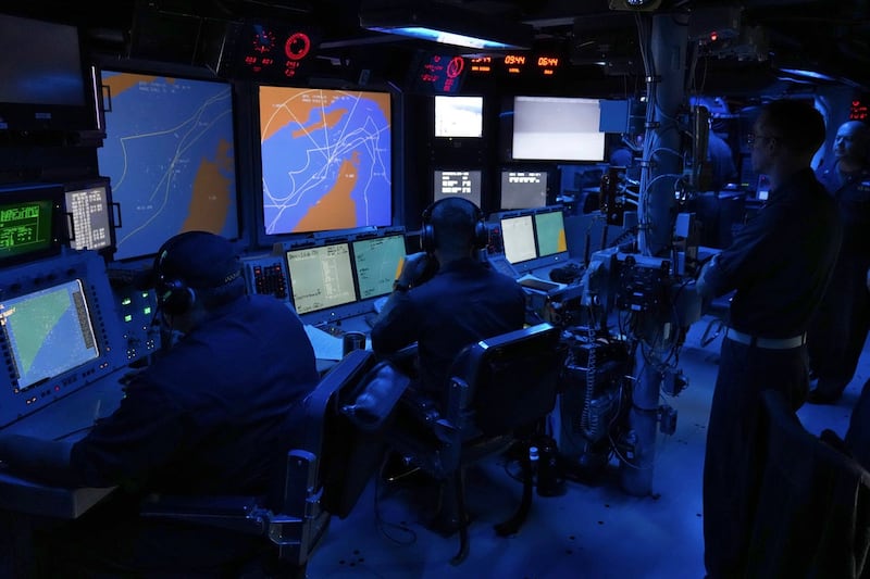 US Navy sailors work in the Combat Information Center of the USS Paul Hamilton in the Strait of Hormuz