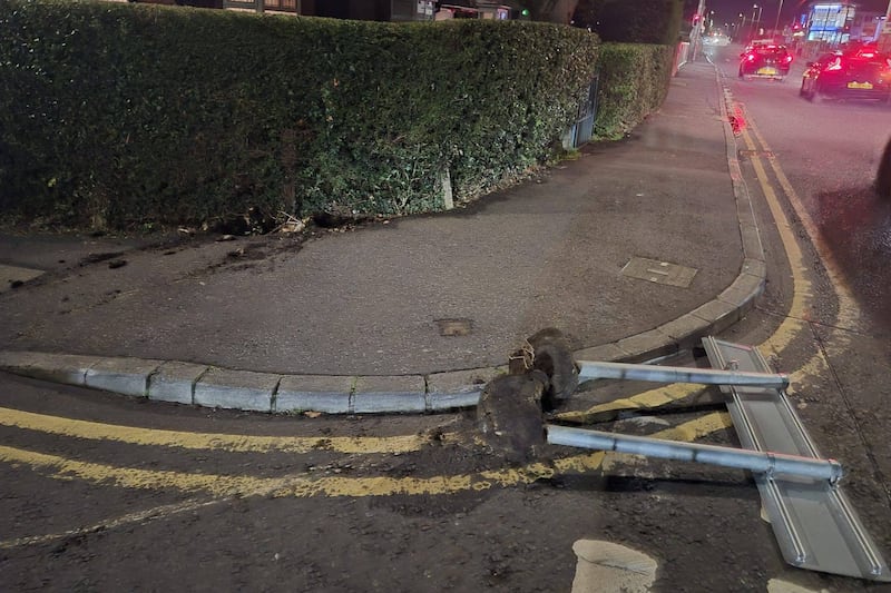 Irish-English language street sign ripped out of tarmac base