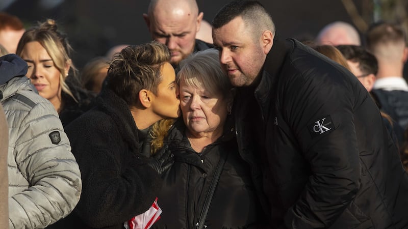 Lurgan murder victim Odhrán Kelly's mother Jacqueline (centre) is comforted by family at his funeral on Sunday. Picture by Mark Marlow.