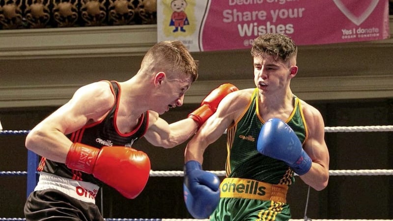 Diarmuid Toland (Holy Family) lands a right hand on Cookstown&#39;s Craig Bigger en route to the Ulster Elite light-flyweight title. Picture by Philip Walsh 