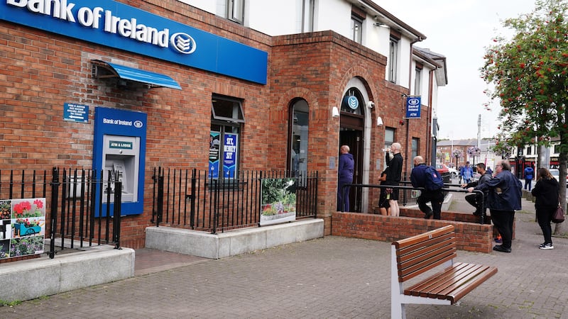 People queue to enter a Bank of Ireland branch in Finglas village, Dublin (PA)