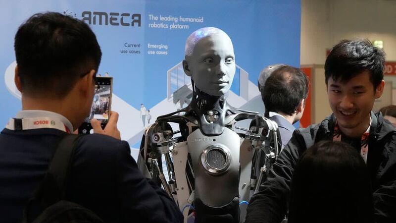 A robot designed by Engineers Arts and called Ameca, interacts with visitors during the International Conference on Robotics and Automation ICRA (Frank Augstein/AP)