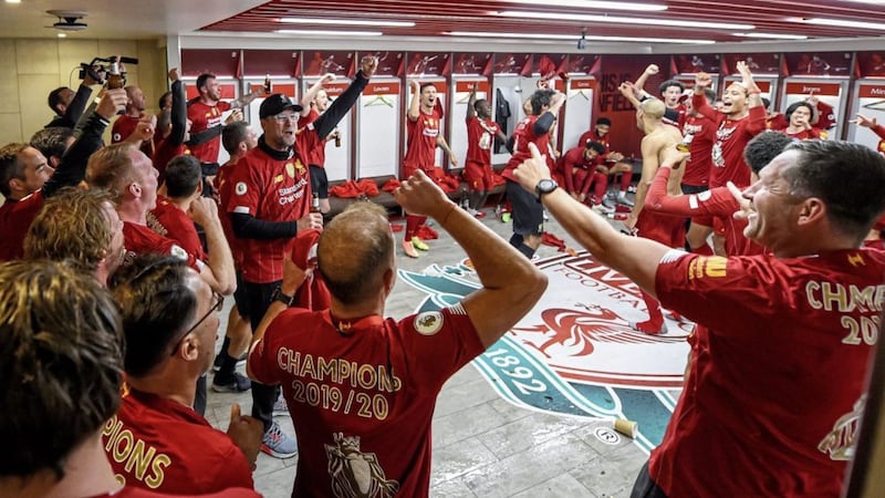 Liverpool FC players and managerial team, including Jurgen Klopp (left of centre with baseball cap), celebrate their historic Premier League win in July in a scene from The End Of The Storm 
