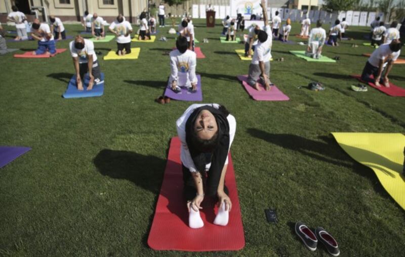 Afghans and foreigners perform yoga to mark International Yoga Day at the Indian Embassy, in Kabul (Massoud Hossaini/AP)
