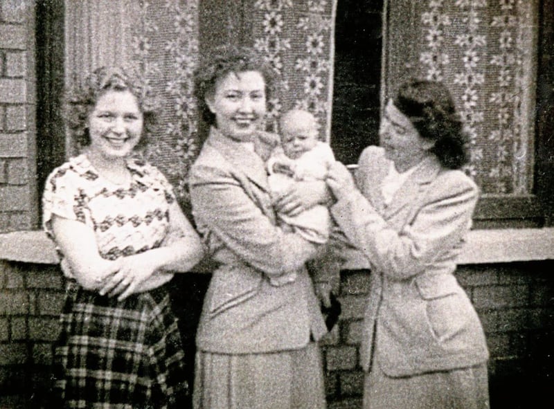 Former president Mary McAleese as a baby, in the arms of one of her dad&#39;s cousins, with her mother, left, and another relative. Picture courtesy of Mary McAleese 