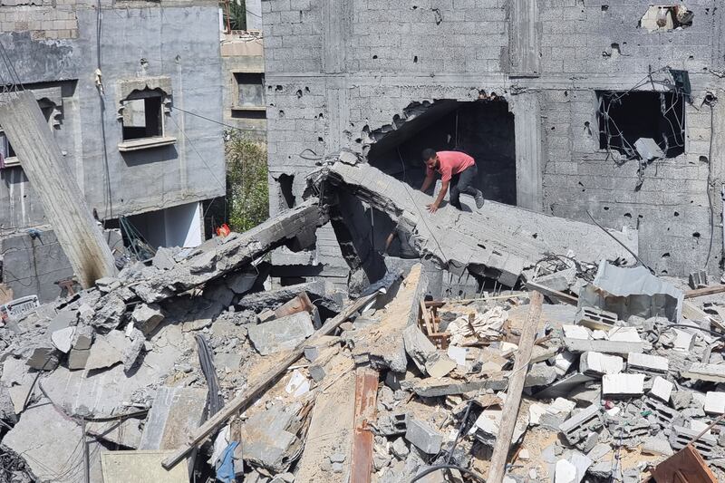 Buildings destroyed in an Israeli air strike on Rafah (Mohammad Jahjouh/AP)