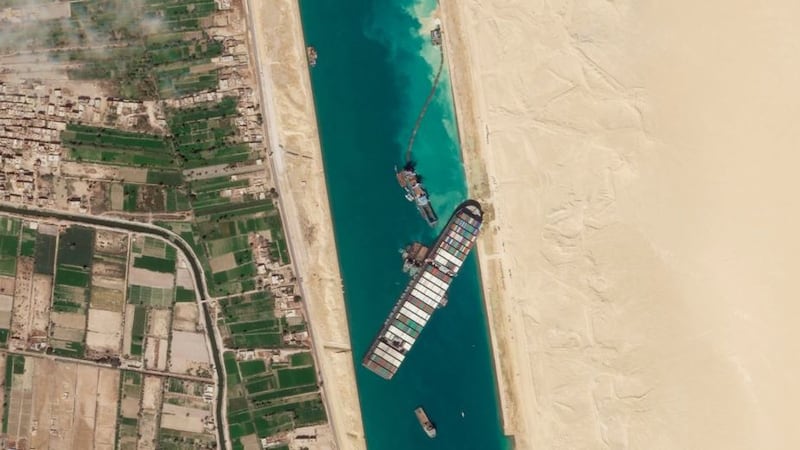 In this satellite image from Planet Labs Inc from March 28 2021, the cargo ship MV Ever Given sits stuck in the Suez Canal near Suez, Egypt