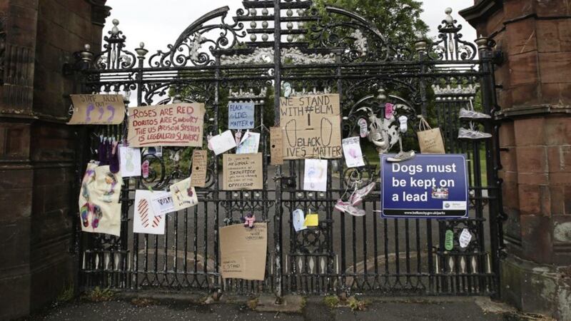 The scene at Ormeau Park where artwork, socks and shoes hang on the gates and railings. Picture by Hugh Russell 