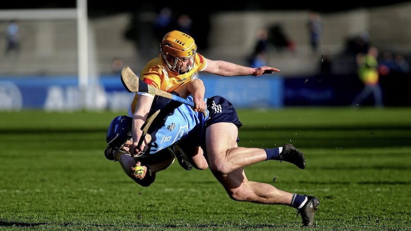 Dublin&#39;s Paul Crummey comes off worse for wear after a challenge from Antrim corner-back Phelim Duffin during the NHL Division 1B clash at Parnell Park. Picture by Seamus Loughran 