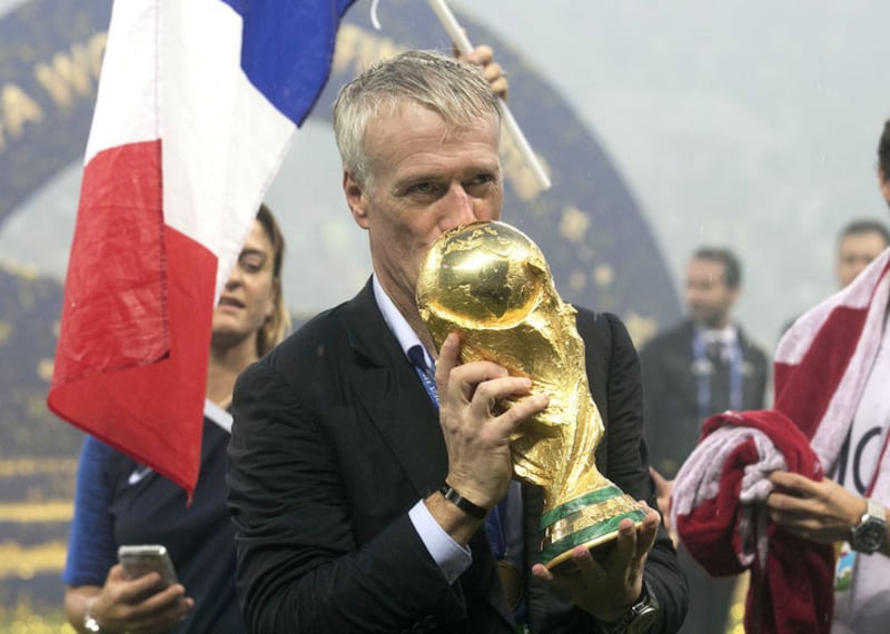France head coach Didier Deschamps poses with the trophy after his team won the FIFA World Cup Final at the Luzhniki Stadium in Moscow