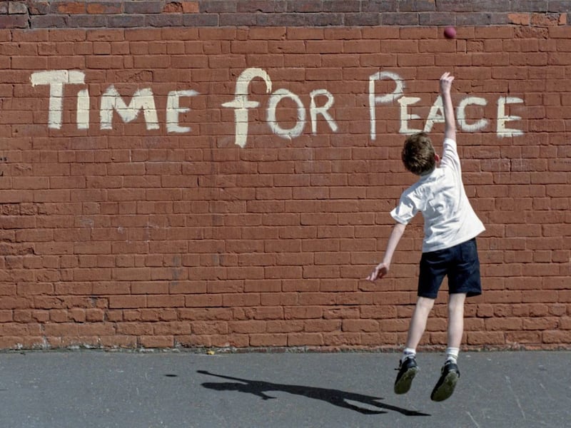 A boy playing on the Antrim Road in north Belfast before the 1994 IRA ceasefire. Picture by Crispin Rodwell 