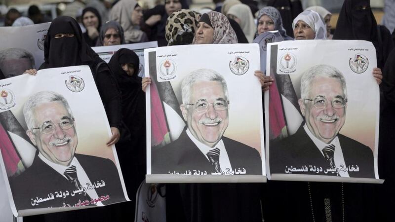Women hold posters of Palestinian president Mahmoud Abbas in Gaza City PICTURE: Khalil Hamra/AP 