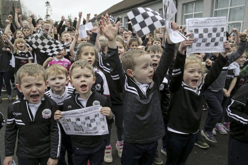 Pupils from St Malachy&#39;s Primary School cheering on Kilcoo. Picture by Hugh Russell 