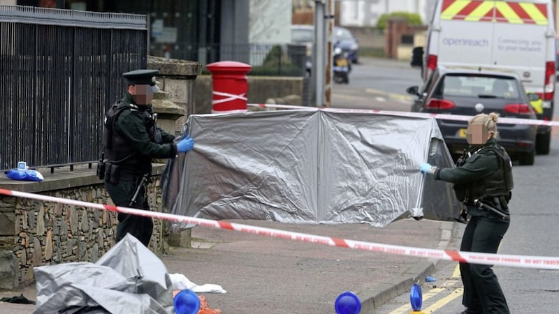 PSNI officers at the scene of Monday&#39;s killing in Downpatrick&#39;s Church Street. Picture by Mal McCann 