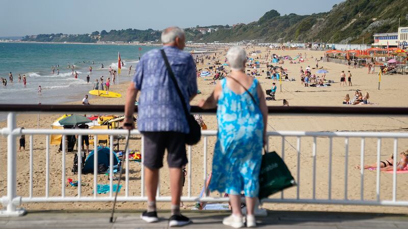 People look out from Bournemouth pier towards Bournemouth beach in Dorset (Andrew Matthews/PA)