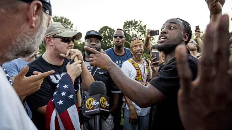 Isaiah Moore, right, argues with counter demonstrators about race relations during a rally in Coolidge Park in Chattanooga, Tennesse PICTURE: Doug Strickland/Chattanooga Times Free Press via AP 