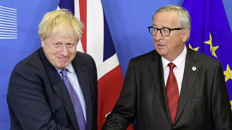 Prime minister Boris Johnson and Jean-Claude Juncker, president of the European Commission, shake hands on the Brexit deal which has left unionists isolated from Britain. Picture by Stefan Rousseau/PA Wire 