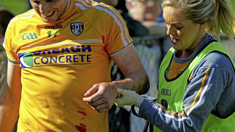 Antrim&#39;s Michael Armstrong leaves the field with a broken arm Pic Seamus Loughran 