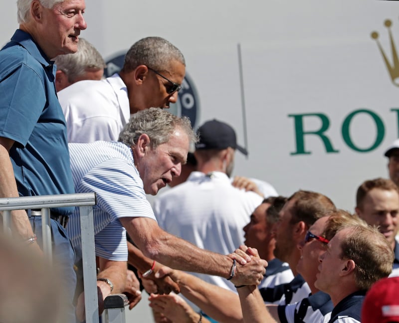 Former US presidents Bill Clinton, George Bush and Barack Obama greet the US team at the Presidents Cup