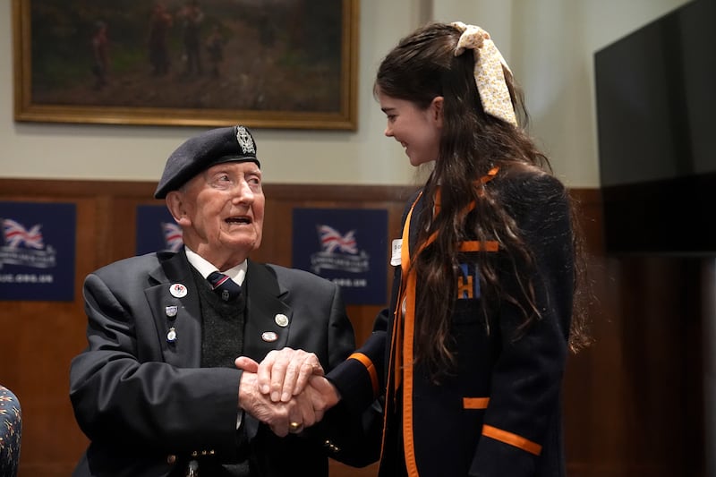 D-Day veteran and Ambassador for the British Normandy Memorial Stan Ford, 98, who served with the Royal Navy, meeting a pupil from Norfolk House School