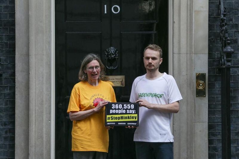 Stop Hinkley campaigner Sue Aubrey and Richard Casson (right) from Greenpeace UK hand a petition to Downing Street in London, calling on Prime Minister Theresa May to drop Hinkley and invest in renewable power instead. Daniel Leal-Olivas/PA Wire