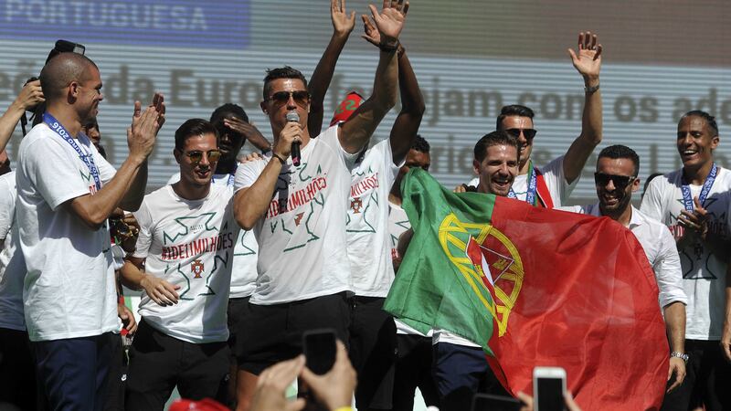 Portugal's Cristiano Ronaldo salutes the fans in Lisbon on Monday. Hundreds of thousands of jubilant people lined the sunbaked streets of the Portuguese capital to greet the national football team after they arrived back from winning the European Championship, their first major trophy<br />Picture by AP