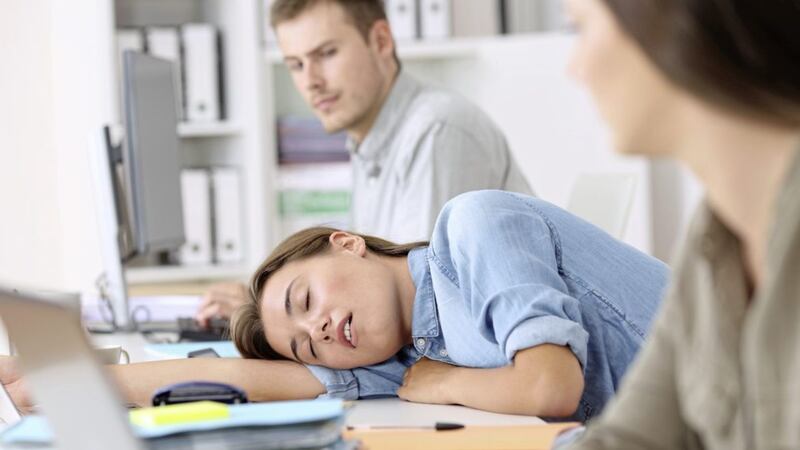 Fatigued employee sleeping at office 