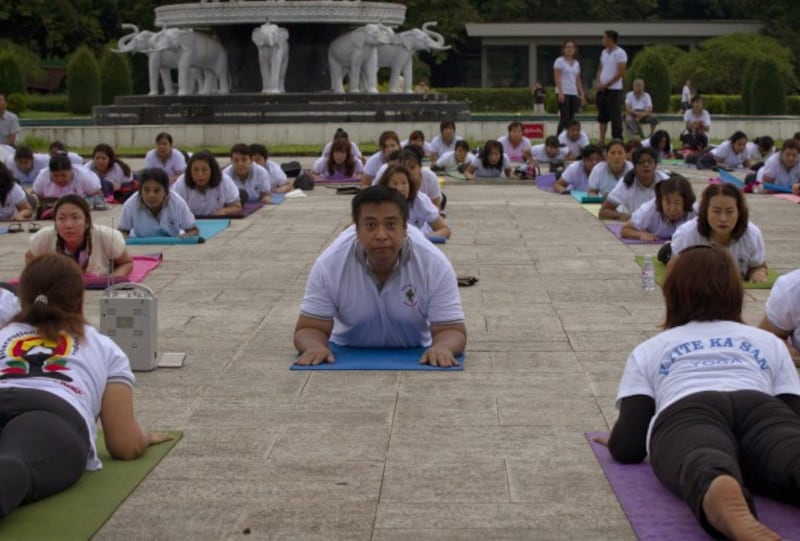 People practice yoga in Yangon, Myanmar (Thein Zaw/AP)