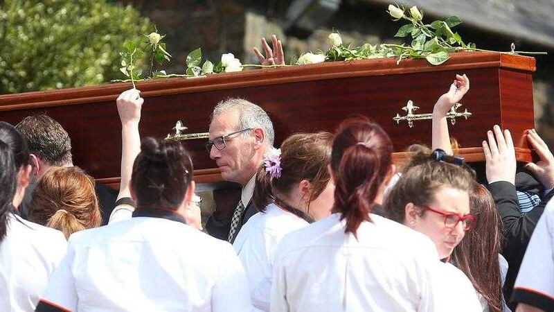 Lorraine Clyde&#39;s work colleagues form a guard of honour and place roses on her coffin as it leaves St Comgall&#39;s church in Antrim Picture Mal McCann 