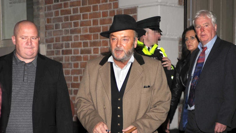 George Galloway (centre) leaves the Ulster Hall in Belfast after a speaking event in August 2014. Picture by Alan Lewis 