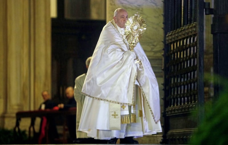 Pope Francis holds up a monstrance during a prayer at the entrance of St Peter&#39;s Basilica. Picture by Yara Nardi/Pool Photo via AP 