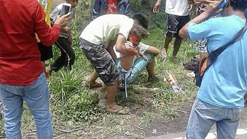 Volunteers try to rescue an injured passenger after a bus apparently lost its brakes and plunged into a deep ravine killing dozens in Carranglan township, Nueva Ecija province in northern Philippines Pitcutre by AP 