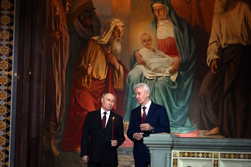 Vladimir Putin, left, with the mayor of Moscow, Sergei Sobyanin, at the service (Pavel Bednyakov, Sputnik, Kremlin Pool Photo via AP)