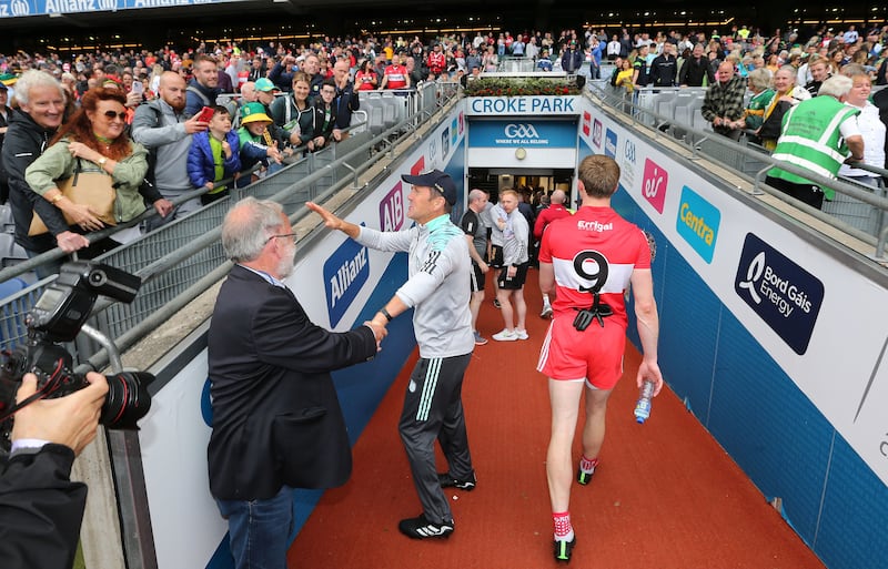 Jack O'Connor is congratulated after Kerry's win over Derry in the All-Ireland SFC semi-final while a disappointed Conor Glass walks down the Croke Park tunnel    Picture: Margaret McLaughlin